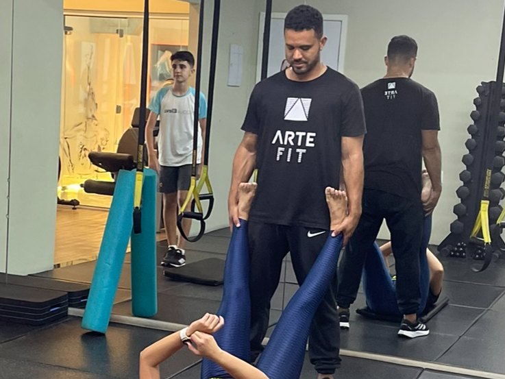 Professor orientando aluna no Arte Fit